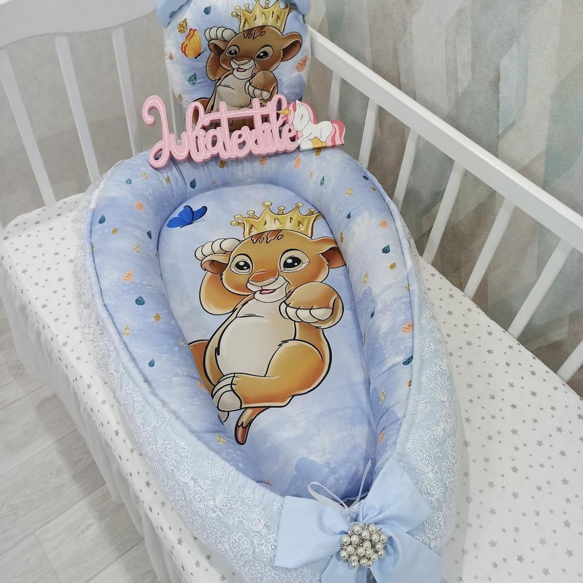 Cocoon decorated with lace and Simba baby print with blue and white crown