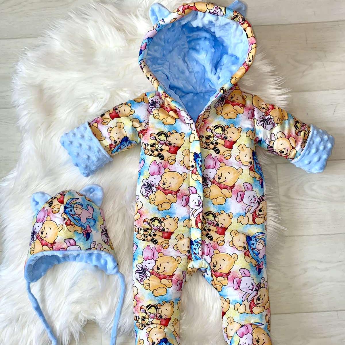 Winter onesie with Winnie the Pooh print colored light blue